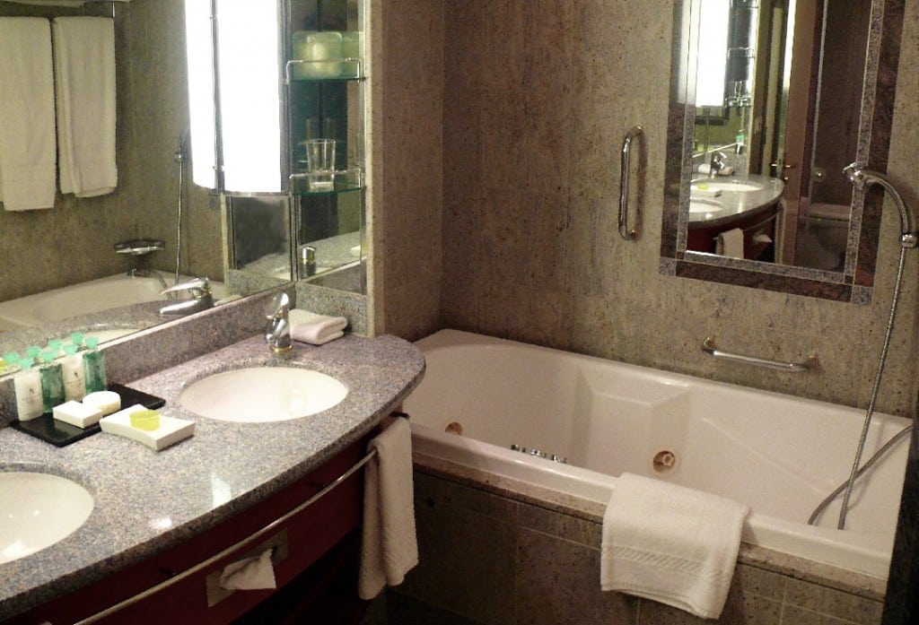 The Silver Suite bathroom featuring double-vanity and Jacuzzi.