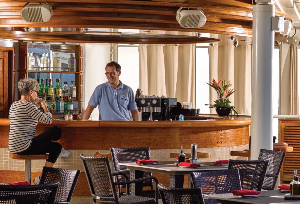 Guests can enjoy a drink by the Silver Whisper's pool bar.