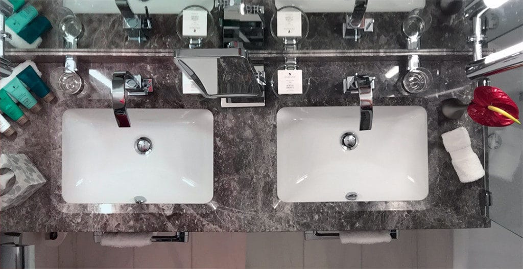 There is plenty of storage space around the double-vanity.