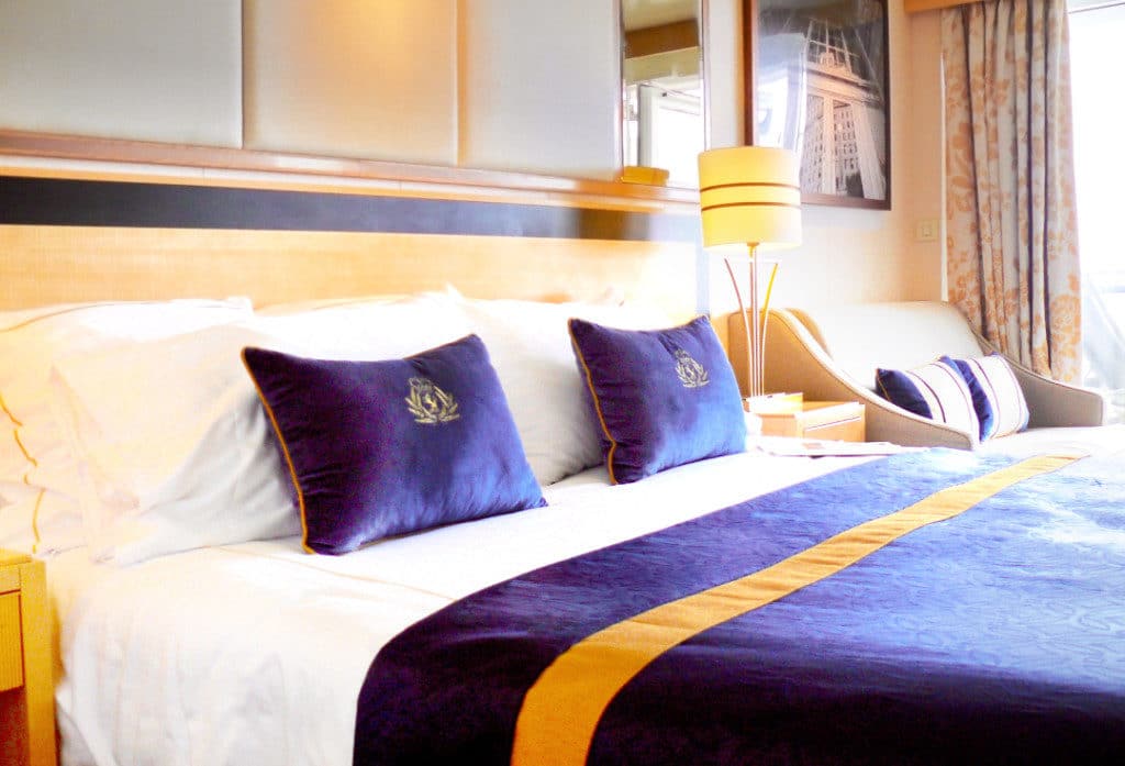 The bed in a Queen Mary 2 Balcony Cabin.