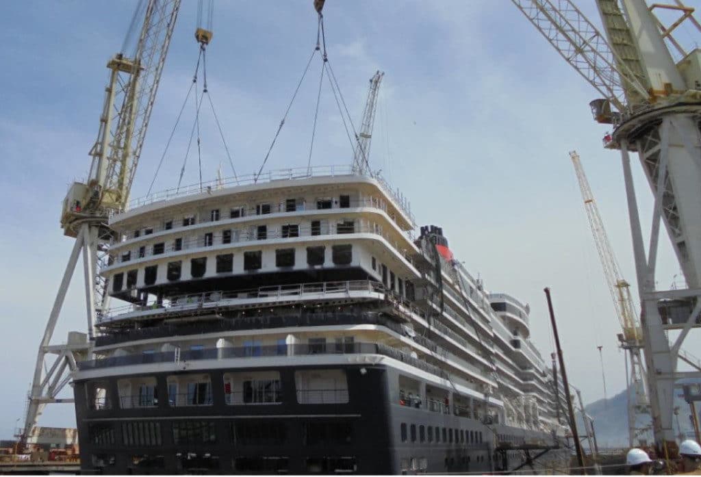 The new extended aft lido sun deck is lifted onto Queen Victoria.