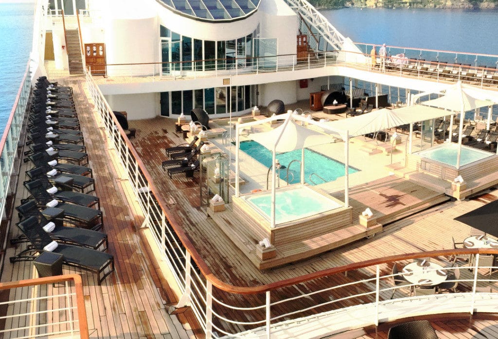 Sun loungers on deck 9 overlook the Seabourn Odyssey pool.