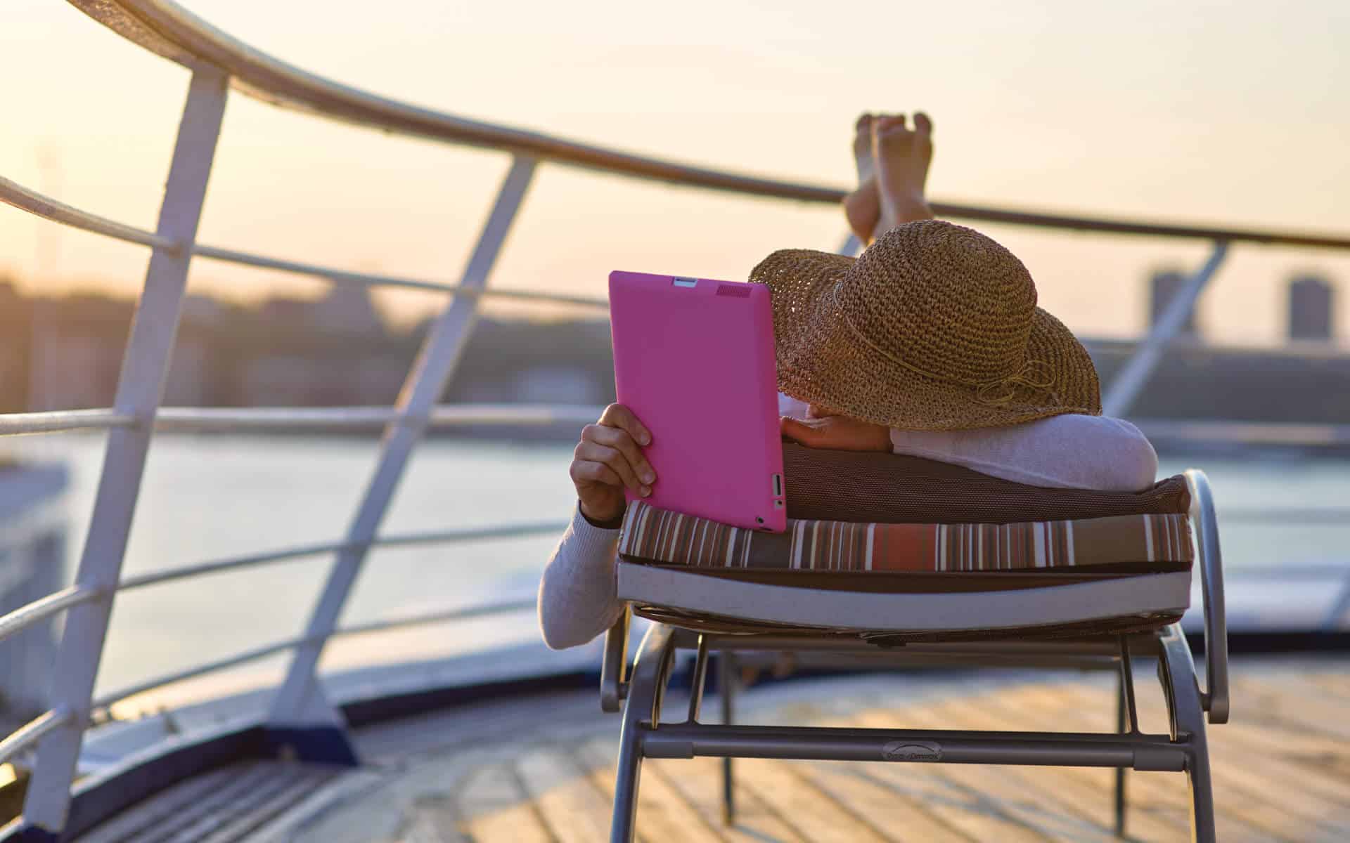 Woman using iPad with one of the Silversea Internet packages.