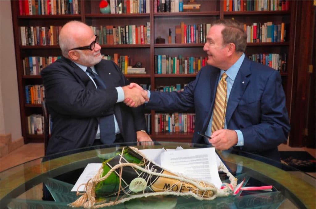 Manfredi Lefebvre D’Ovidio completes the deal with Royal Caribbean Chairman and CEO, Richard D. Fain.
