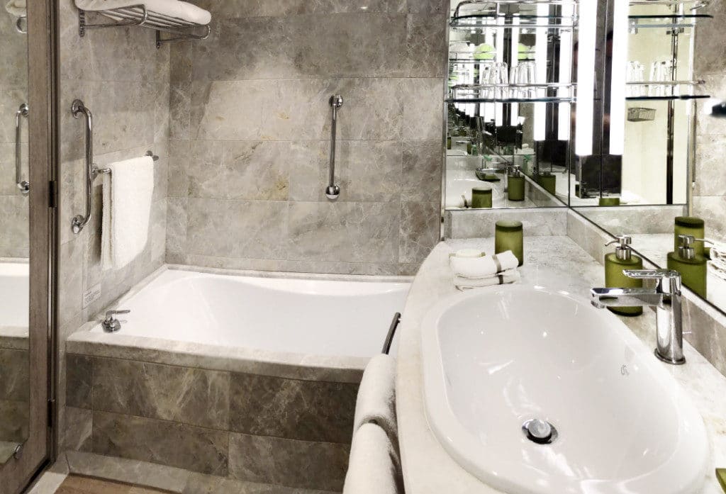 The marble bathroom includes a full size tub.