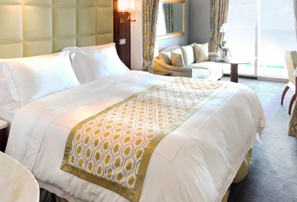 The Seven Seas Voyager Concierge Suite has gold highlights.