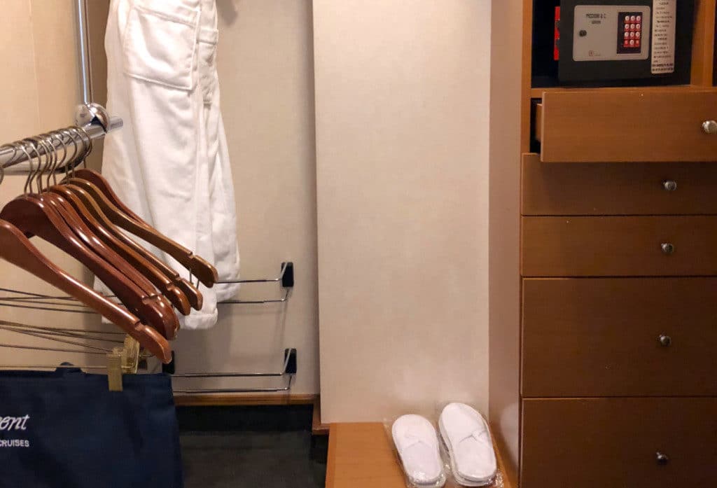 The closet has hanging space and a shoe rack.