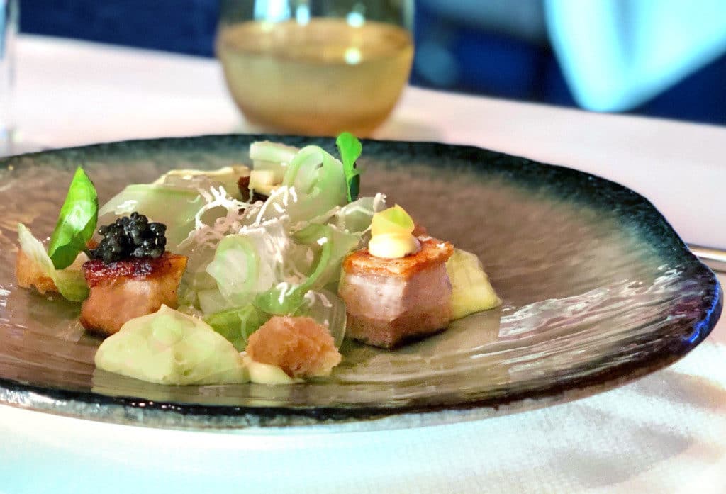 Crispy Pork Belly with Madras Curry, Green Pea Caviar & Goats Cheese.