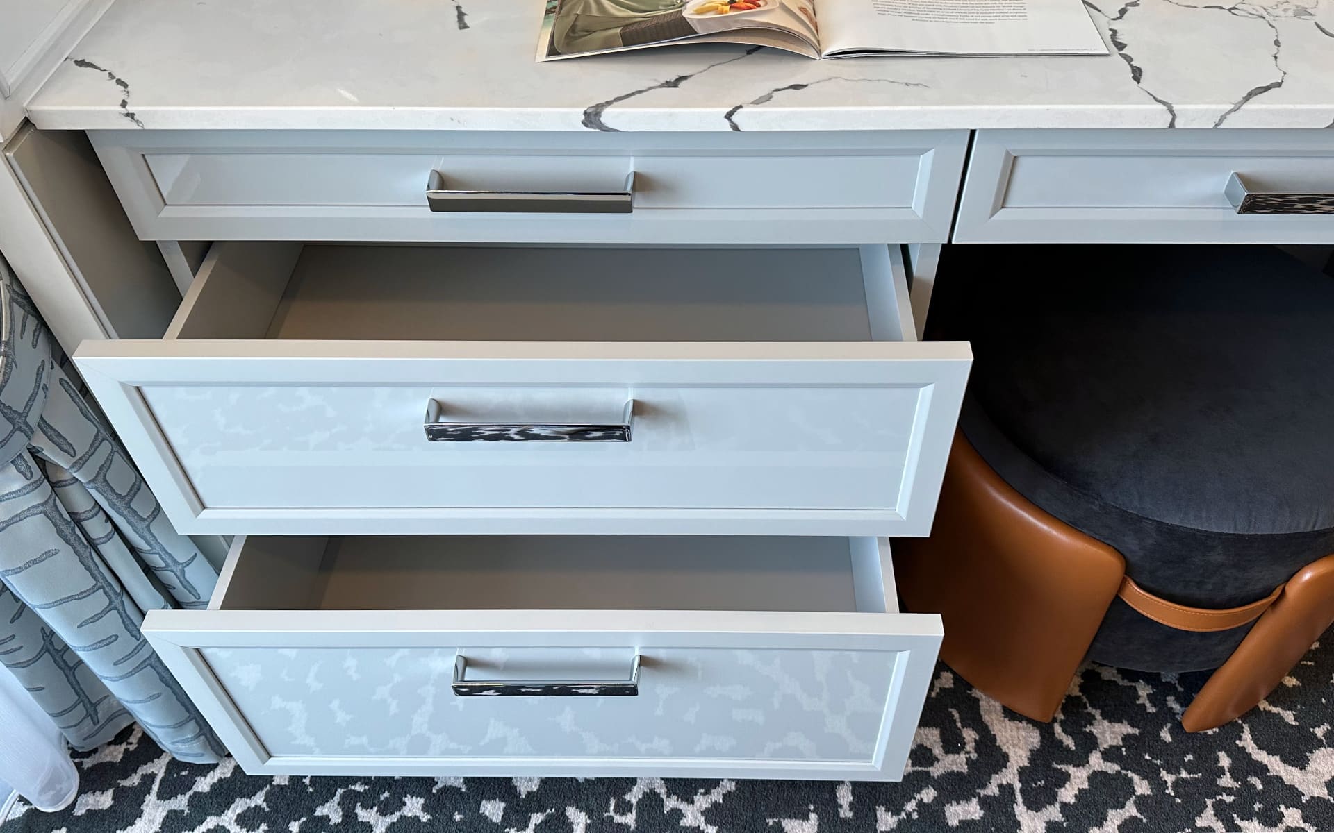 Storage under the writing desk.