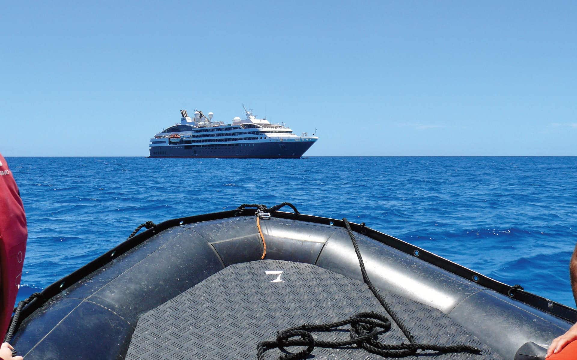 A zodiac returns to L' Austral cruise.ship.