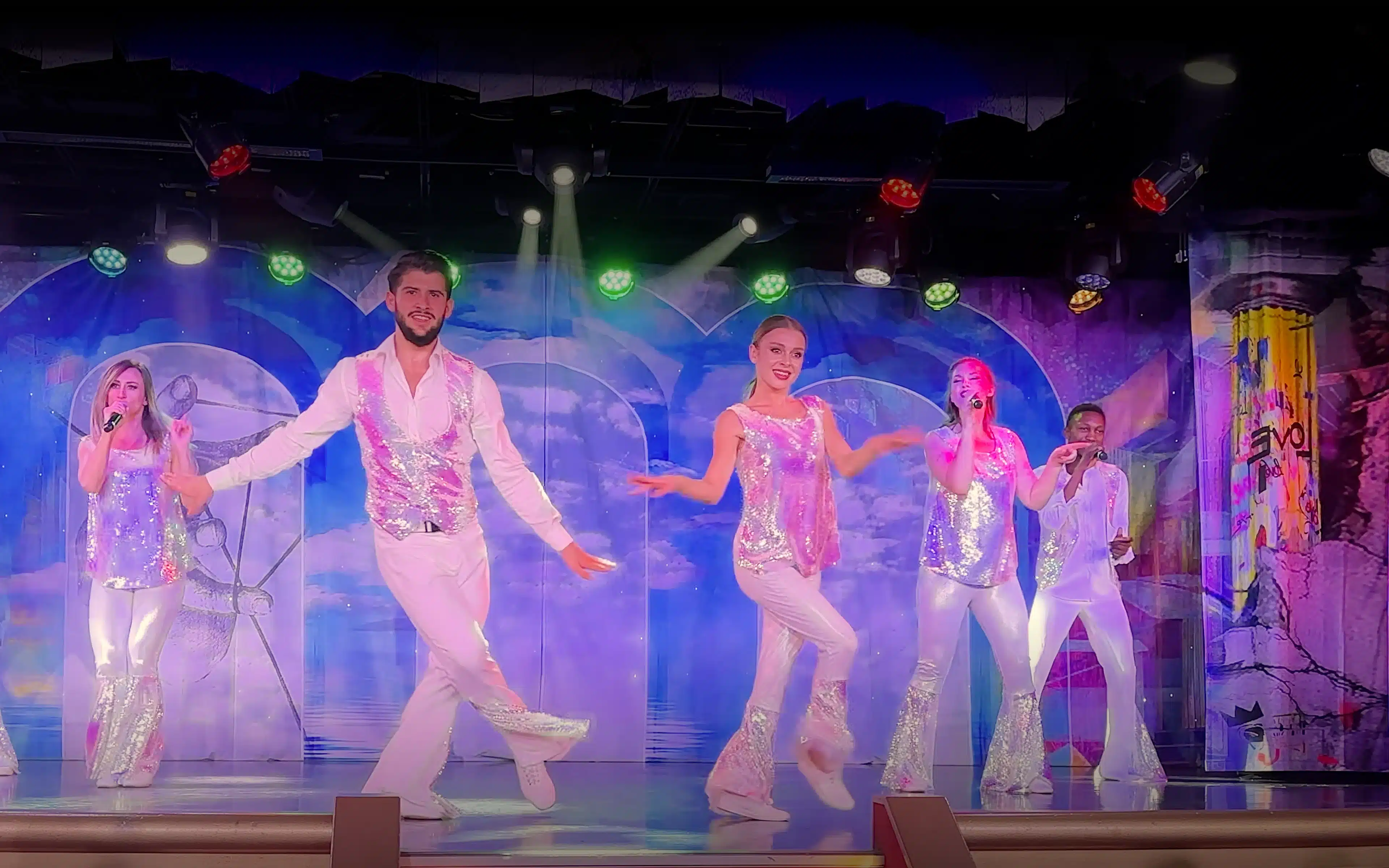 The cast on board Silver Spirit performing on stage.