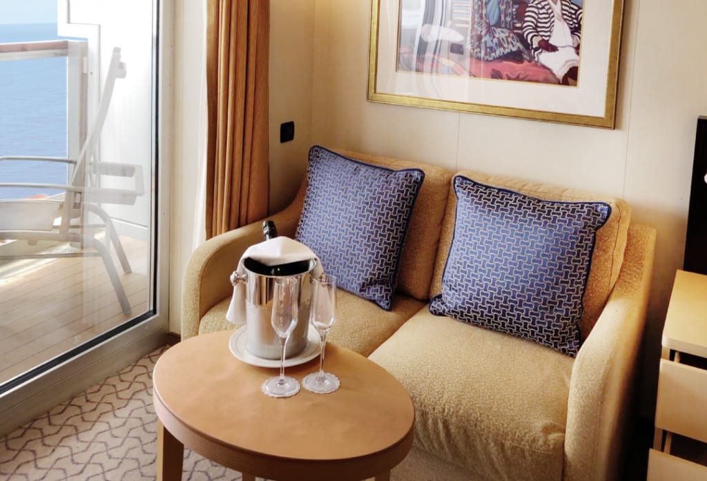 The sitting area in a Queen Elizabeth Balcony cabin.