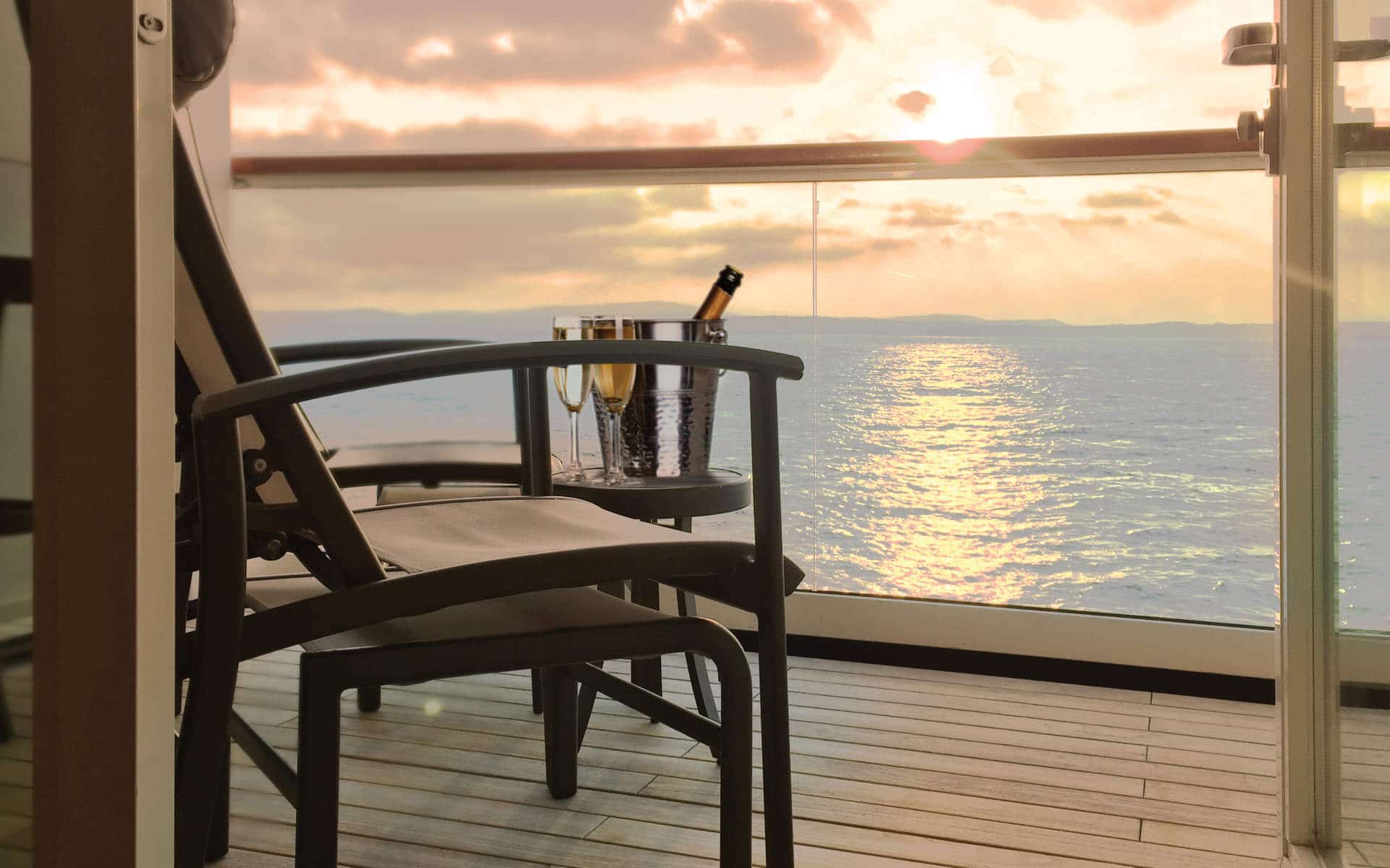 View across a teak balcony toward the ocean.