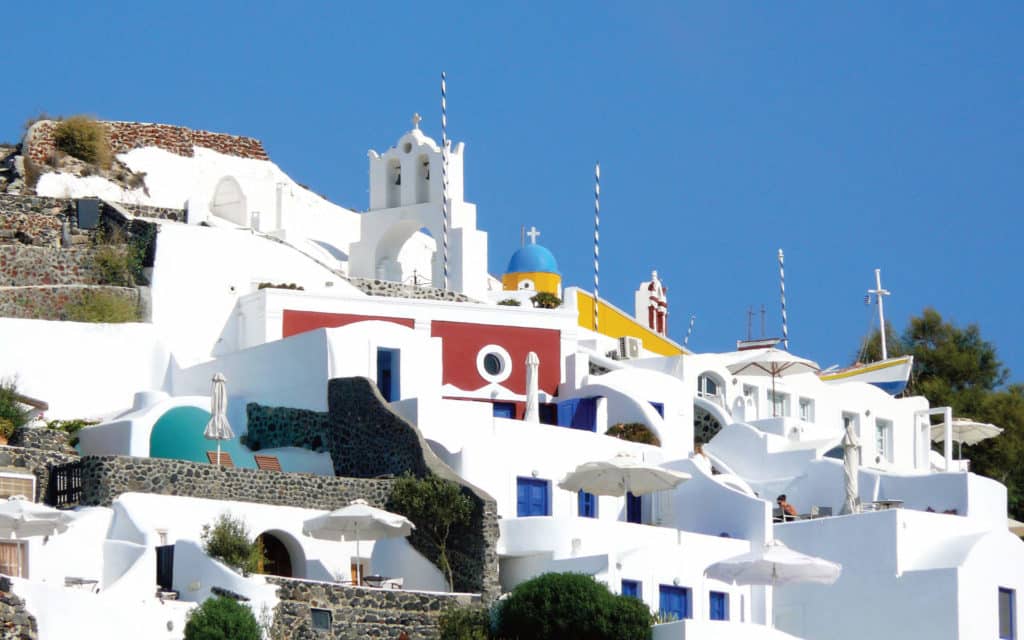 Brightly coloured homes in the village of Oia on Santorini, Greece.
