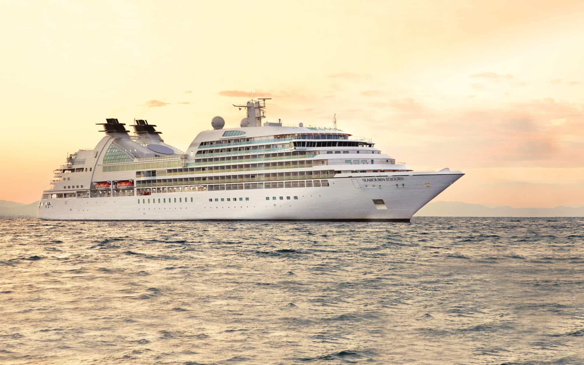 Seabourn Sojourn sailing at sunset.