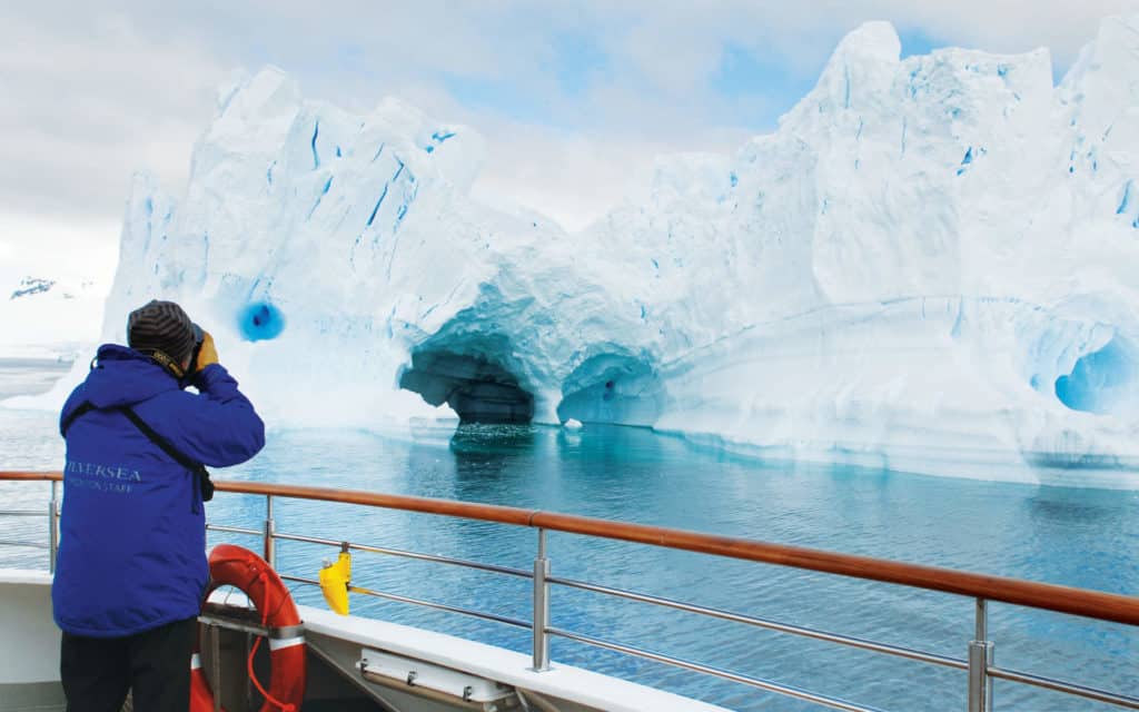 A Silversea guest photographing Antarctic iceburgs.