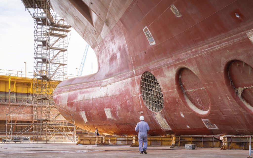 A worker under the troncone section of Queen Anne in the Fincantieri shipyard in Venice, Italy.