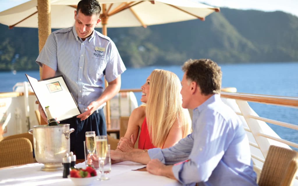 A staff member engaging with guests on a Sea Dream Yacht Club vessel.