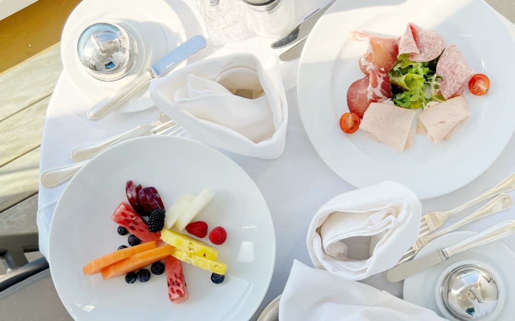 A veranda table set for breakfast.