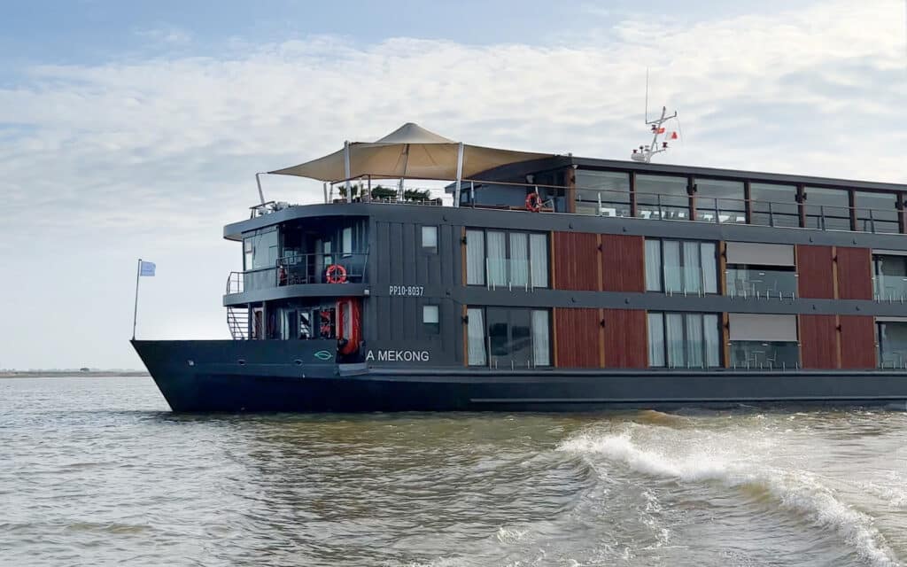 A skif speeding away from the Aqua Mekong river cruise ship.