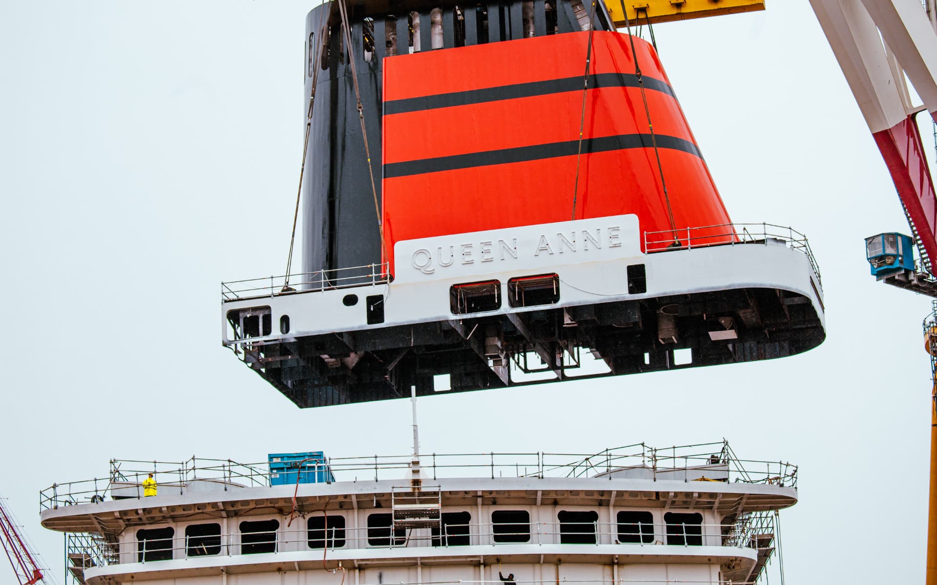 Queen Anne's funnel lifted into place atop the vessel.