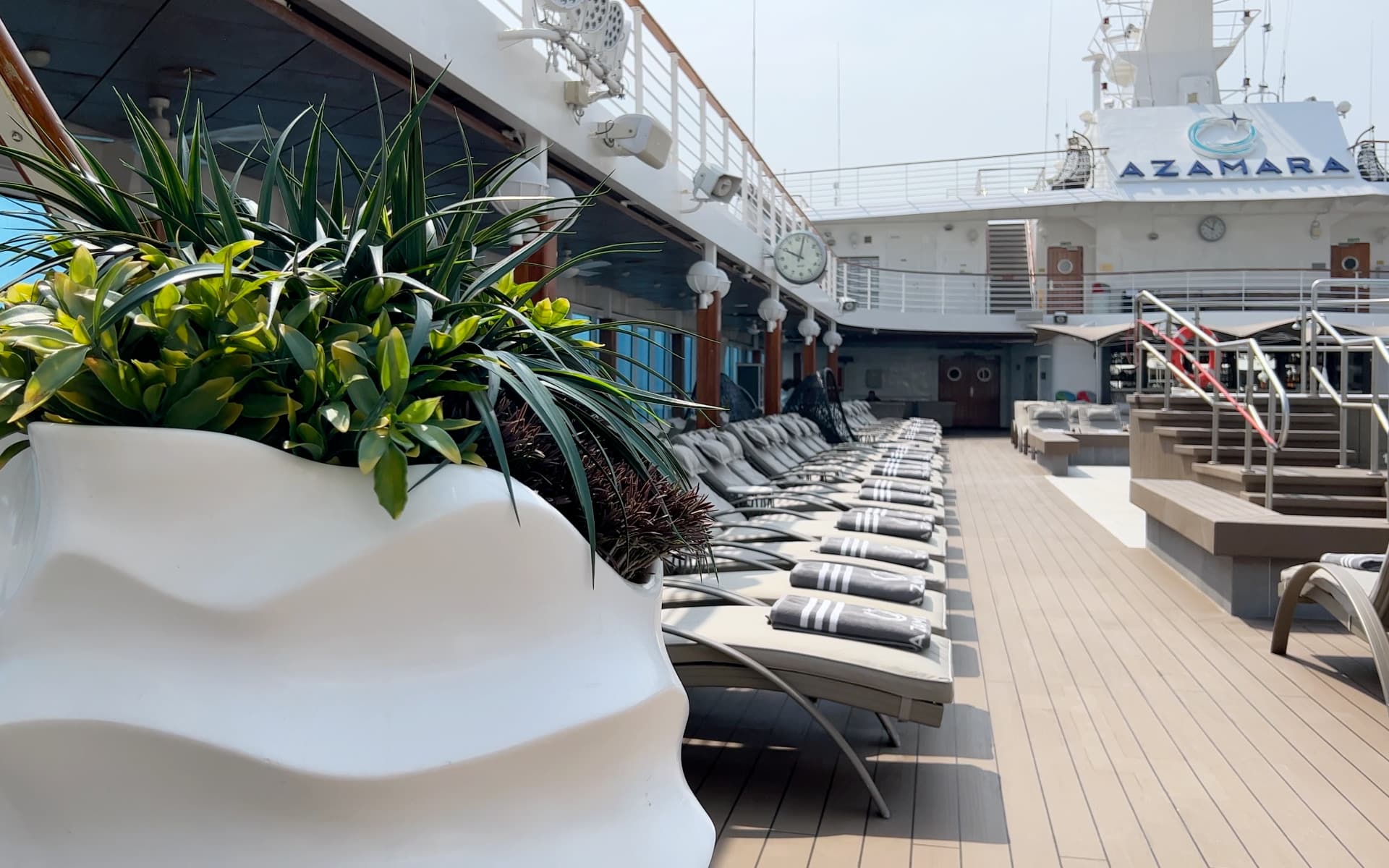 The pool deck with sun loungers.