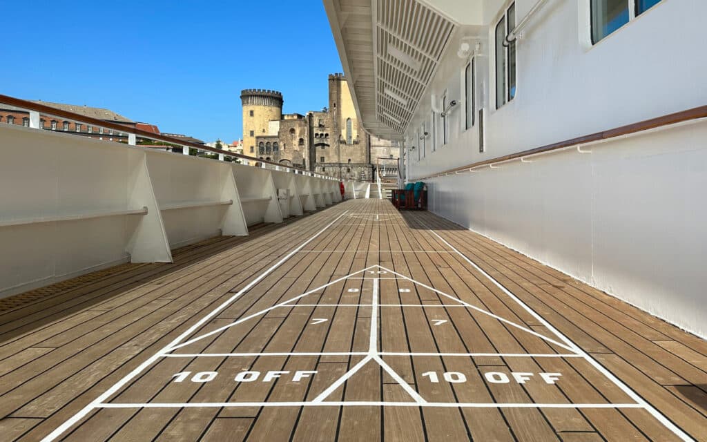 Shuffleboard on a teak cruise ship deck.