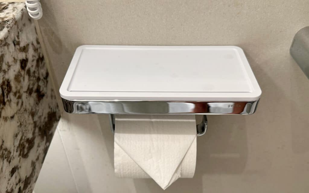 A toilet paper dispenser that doubles as a cell phone holder.