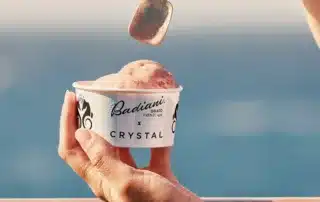 A hond holding a small tub of Badiani gelato.