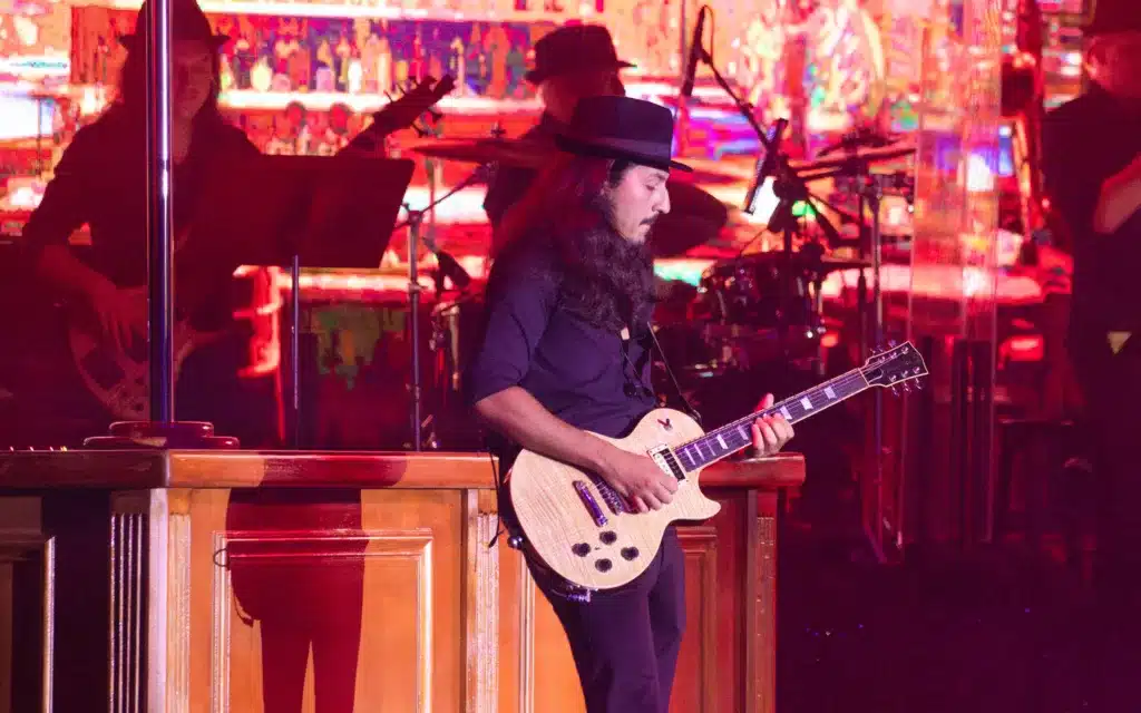 A guitarist performs on stage aboard a Crystal cruise ship.