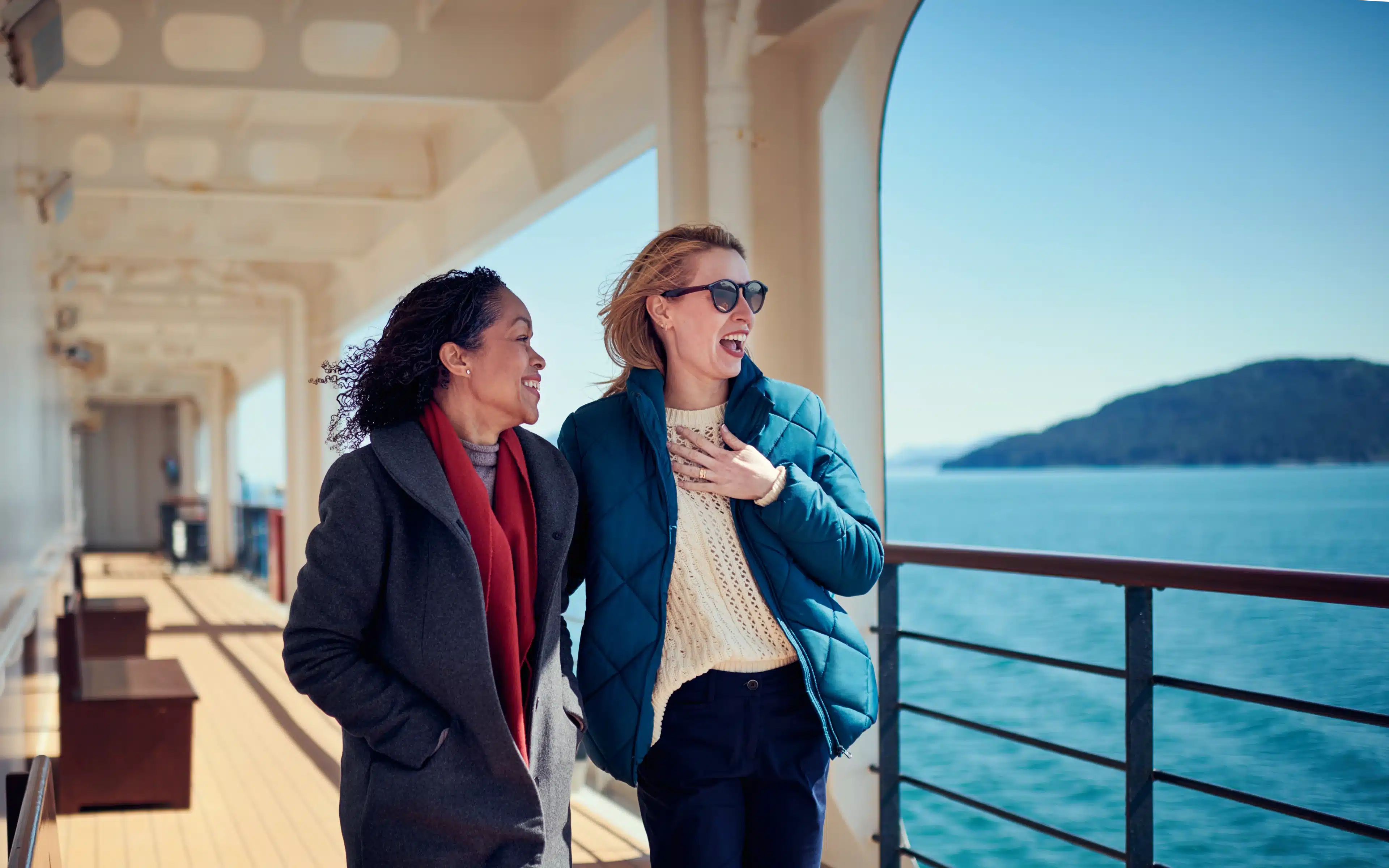 Two female Cunard passengers on deck in Alaska.