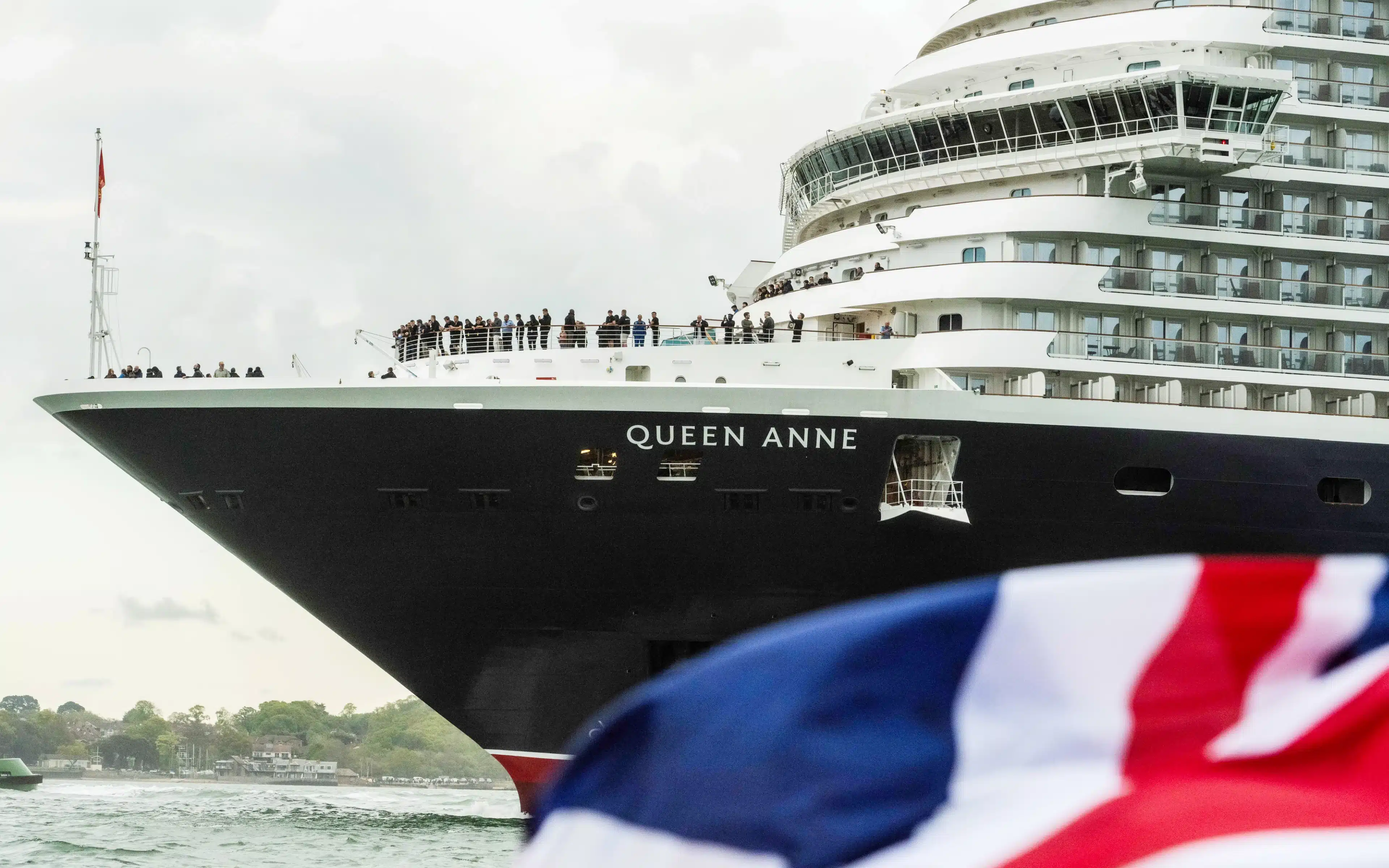 Passengers on the bow of the Queen Anne cruise ship.