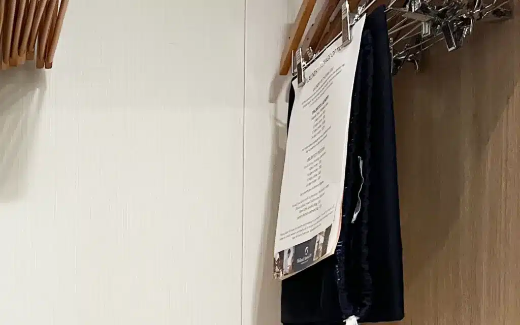 A HAL laundry bag, folded in a closet with hangers.