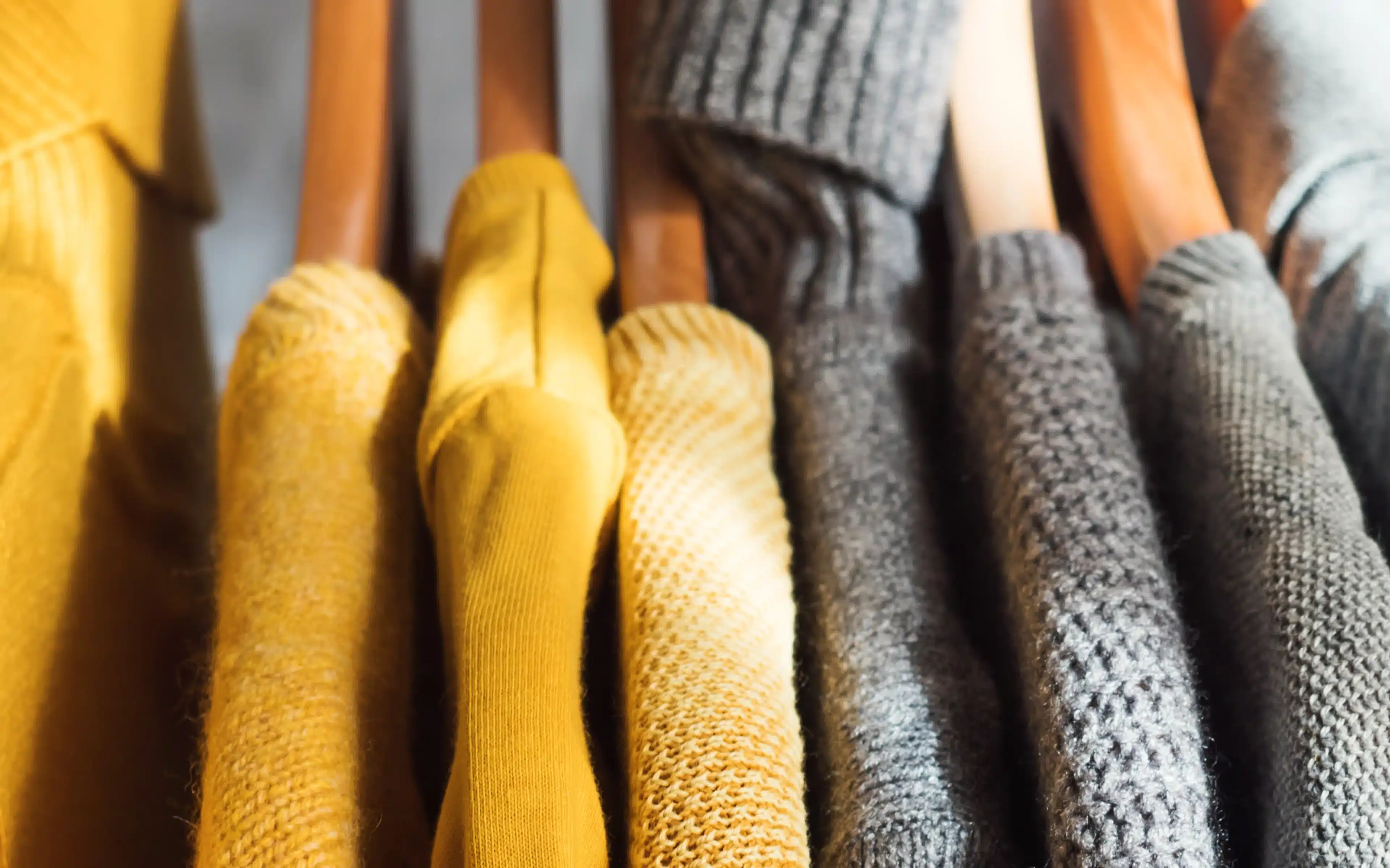 Orange and grey clothes on hangers, the same way that HAL laundry packages return garments.