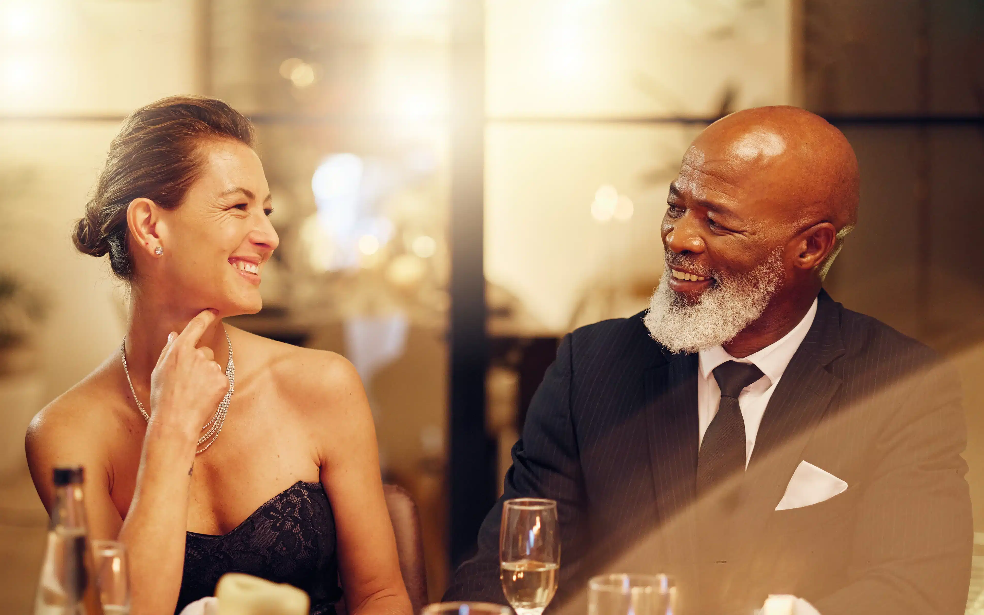 Male and woman in a party celebration wearing elegant attire.