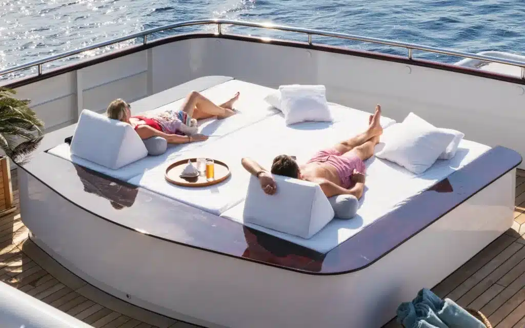 A male and female lying on sun beds.