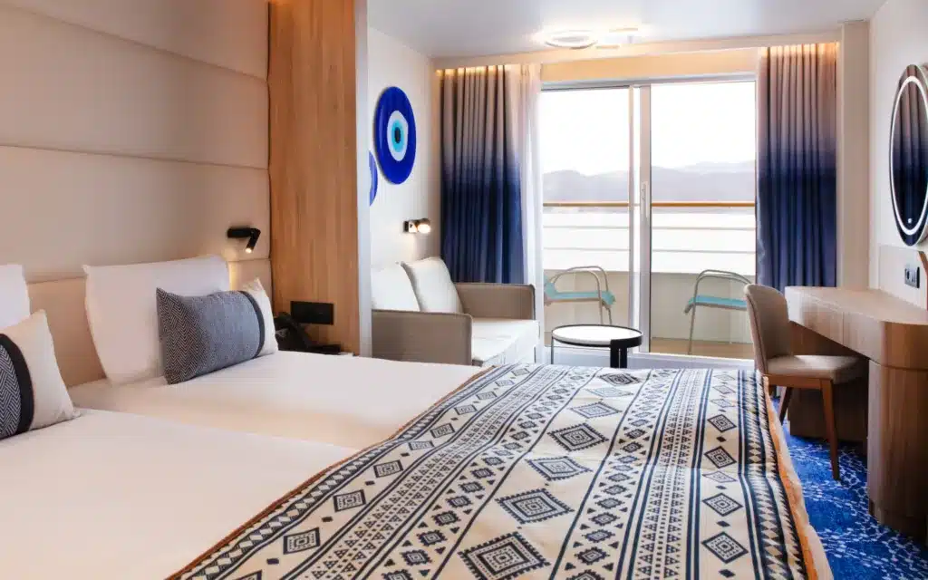 Celestyal Discovery Junior Dream Suite bed and balcony.