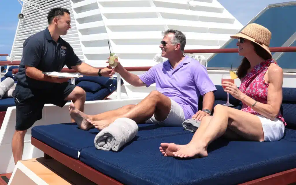 Couple getting refreshments onboard SeaDream under the Caribbean sun