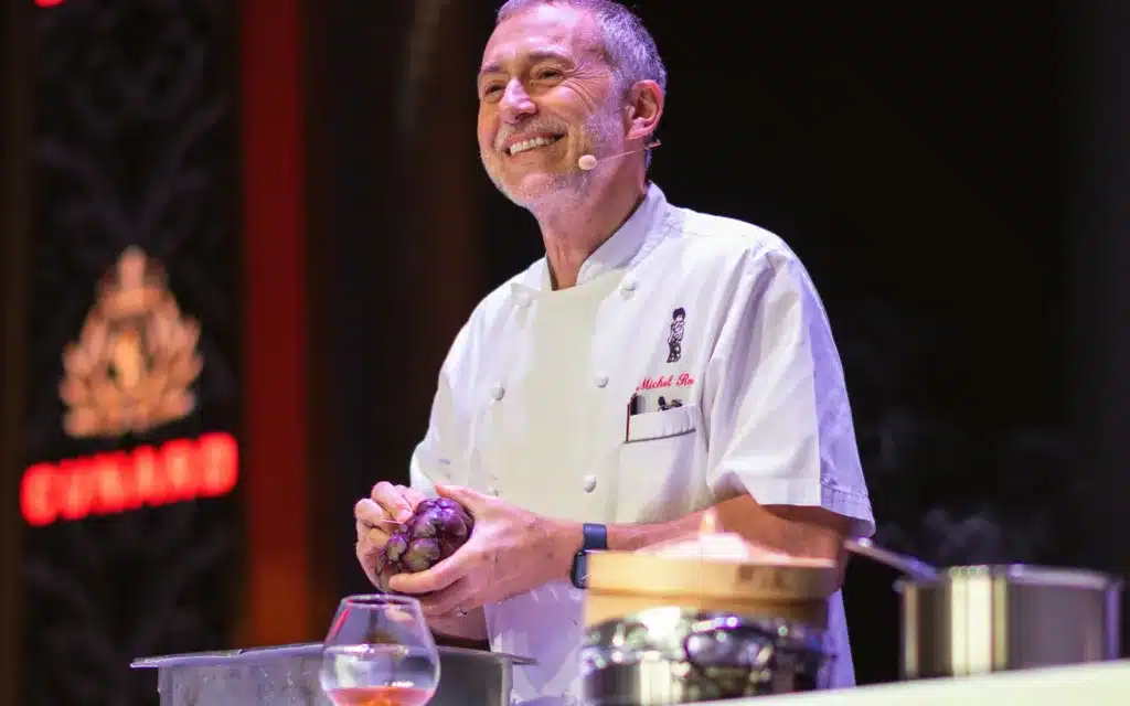 Michel Roux conducting a cooking demonstration on board Queen Anne.