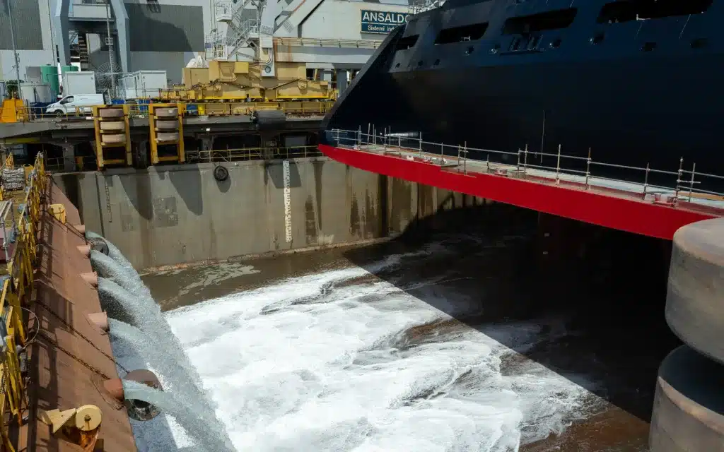 Water from sluice gates floods a dry dock.