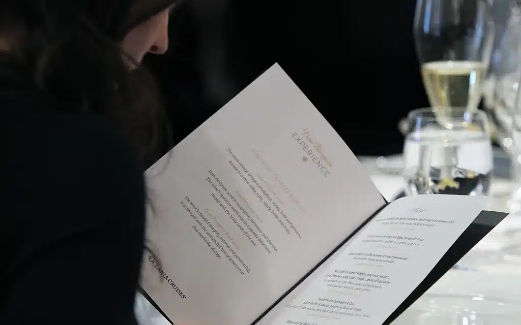 A female browses the Dom Perignon Experience menu.