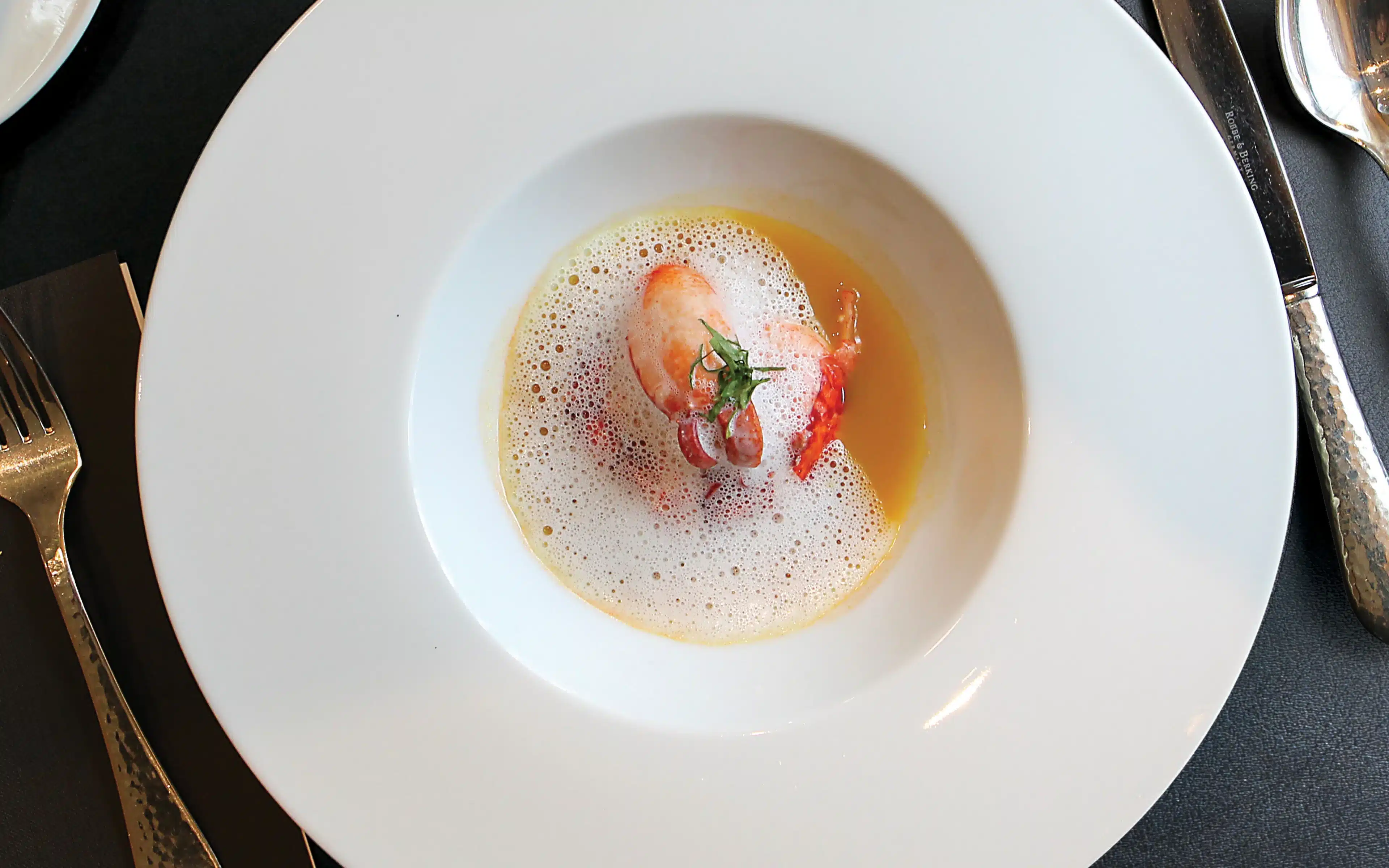 Brittany Blue Lobster in Yellow Curry Broth as served in La Reserve on Oceania Riviera.