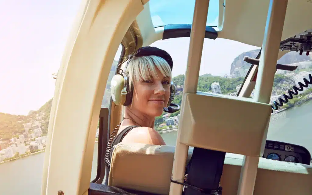 A young woman enjoys a helicoper ride.