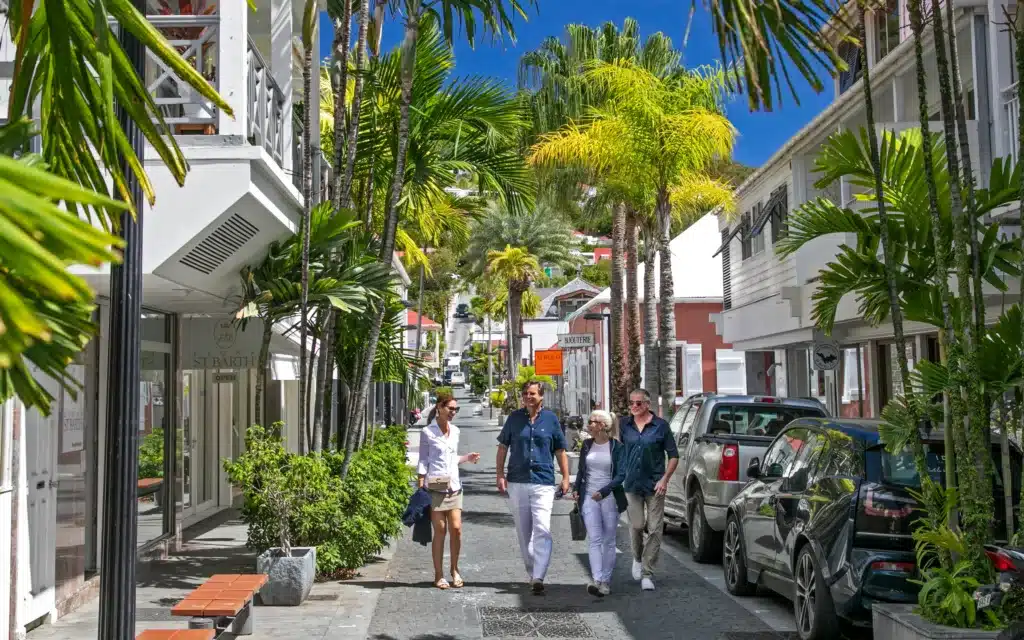 Tourist walking down a street in St. Barths, Bahamas.