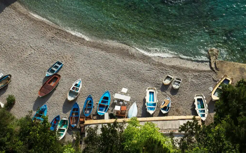 Small fishing boats rest ashore on the Amalfi Coast, Italy.