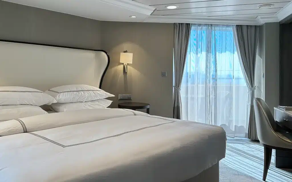 A bedroom in an Owner's Suite on Azamara Pursuit.