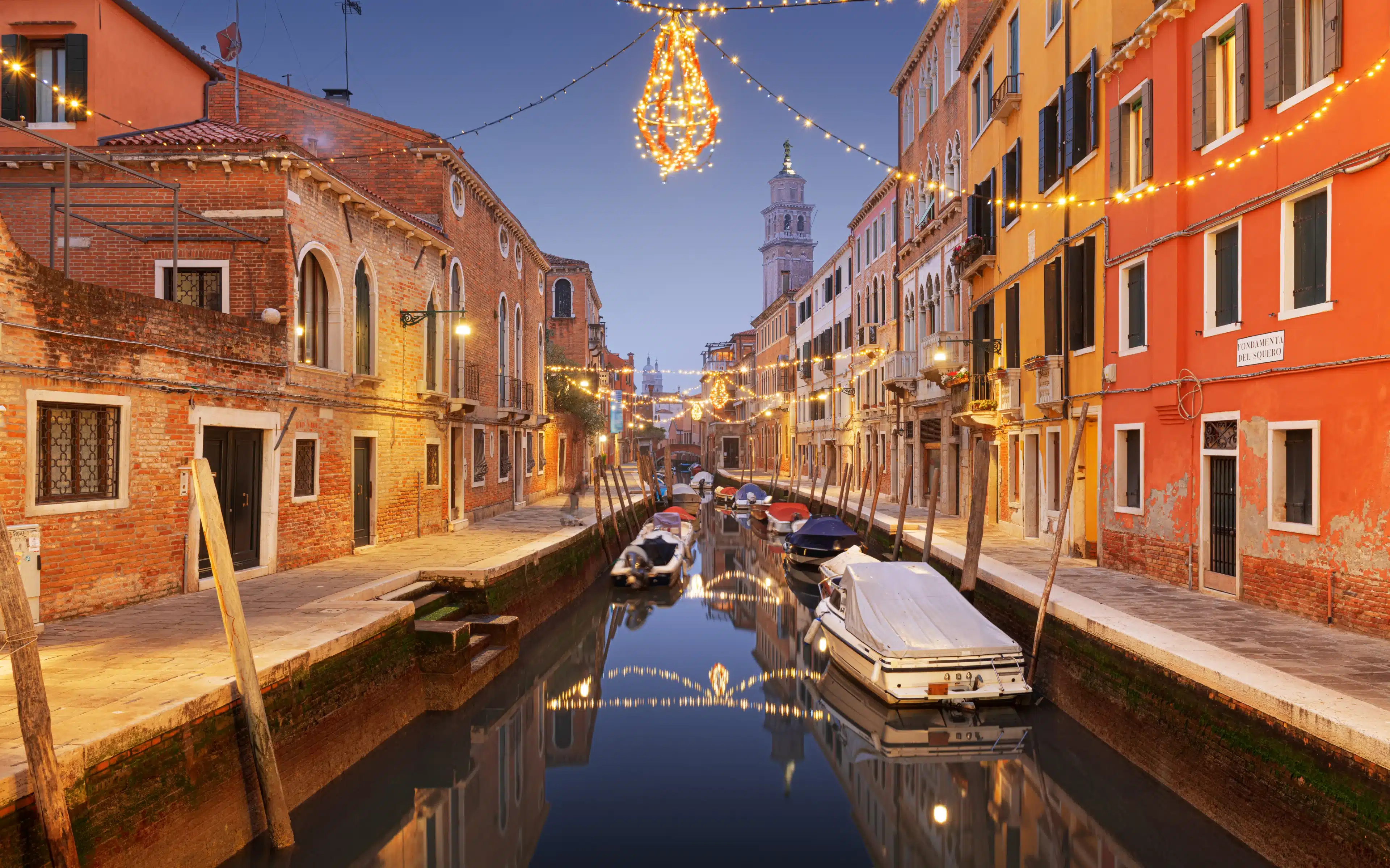 Christmas lights strung across a canal in Venice, Italy.