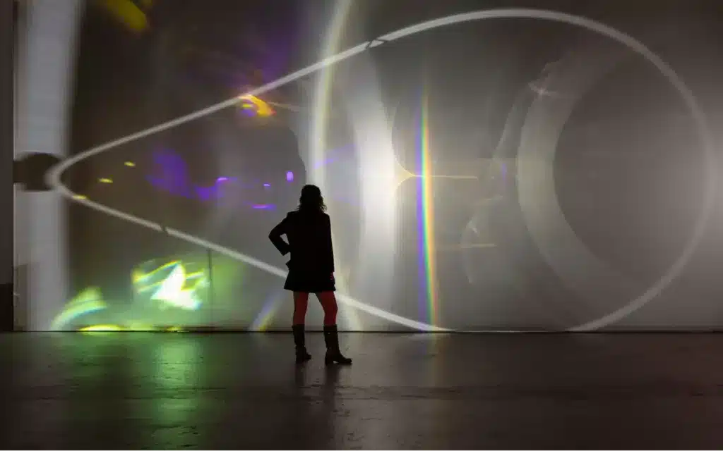 Female immersed in an Olafur Eliasson light installation (courtesy QAGOMA).