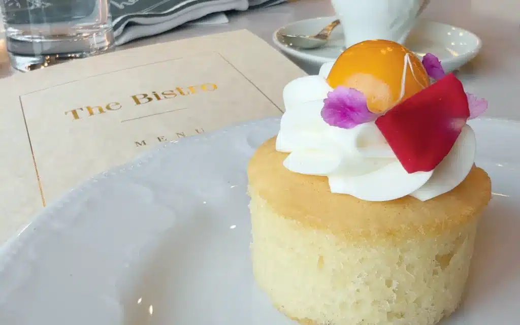 A sponge cake topped with whipped cream and jelly.