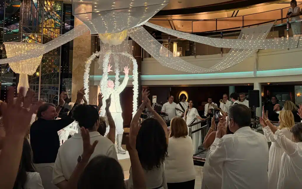 The Cruise Director leads the White Dress Party aboard Crystal Serenity.